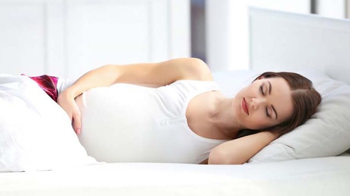 Pregnant Woman Sleeping on Bed