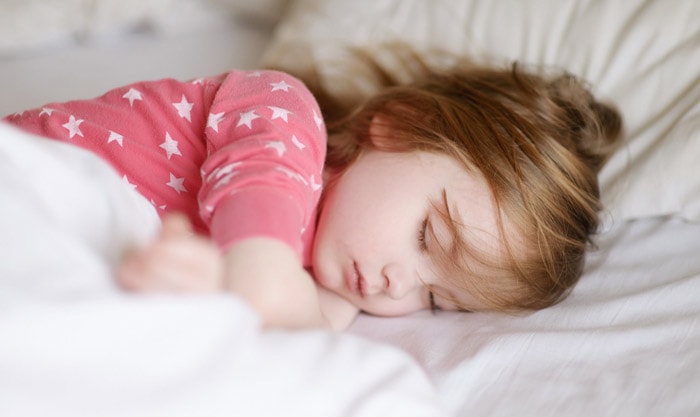 Preschool Girl Sleeping on the Bed